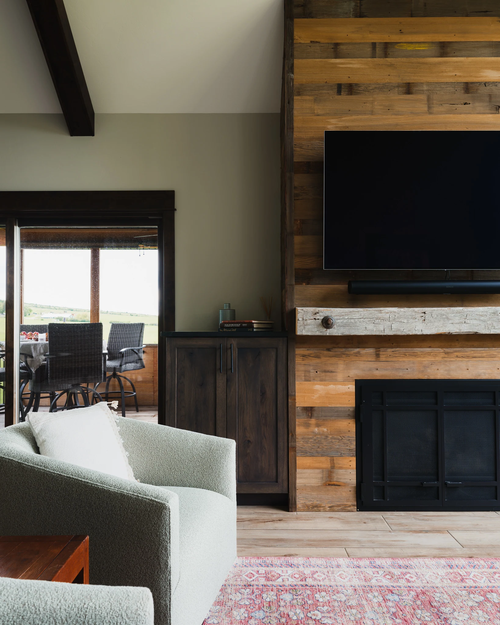 Living room with a reclaimed wood accent wall and mounted television — interior design photography Livingston Montana, Sam Schlauch Designs